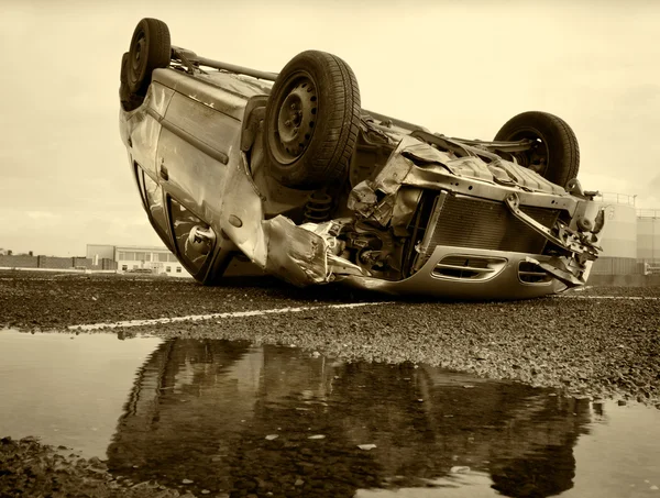 Car turned upside-down, sepia — Stock Photo, Image