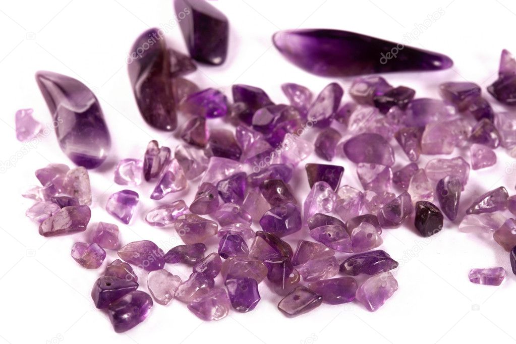 Crystals of amethyst are isolated on a white background.