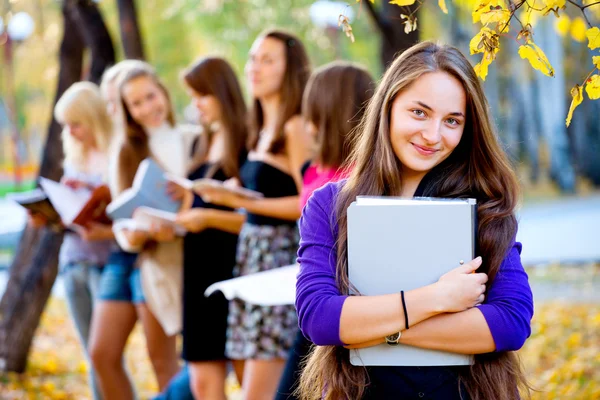 Many students in the autumn park — Stock Photo, Image