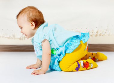 Sweet baby girl sitting on the floor clipart