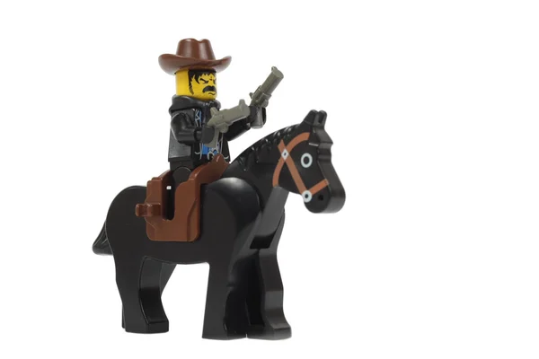 Cowboy brinquedo em um cavalo lego — Fotografia de Stock