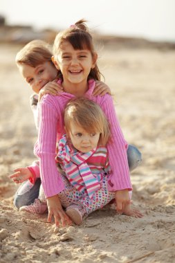 Kids playing at the beach clipart