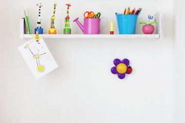 Kids shelf on white wall with toys on it clipart