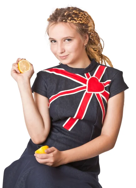 Girl in jean dress with lemons. — Stock Photo, Image