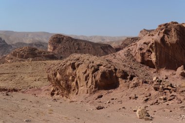 Scenic weathered red rocks in stone desert clipart