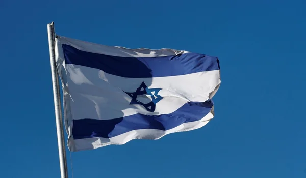 stock image Israel flag waving in the wind against a blue sky