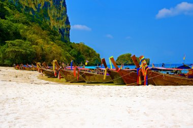 Longtailboats tied up at a beach in Krabi clipart