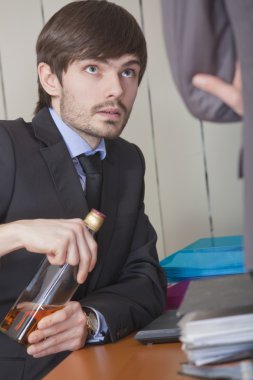 Businessman drinking by the work clipart