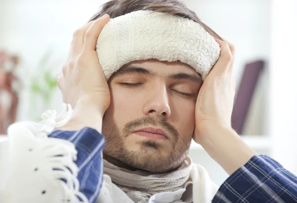 Sick male with wet towel — Stock Photo, Image