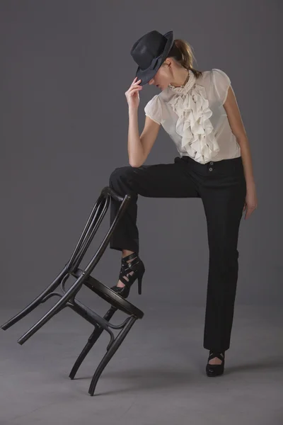Kobieta Tancerz Kapelusz Krzesło Szarym Tle — Zdjęcie stockowe