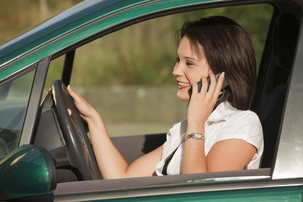 Female with phone driving car — Stock Photo, Image