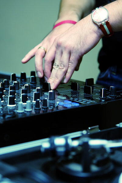 DJ adjusting music level