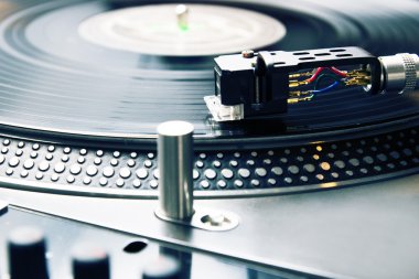 Turntable playing vinyl record with music clipart