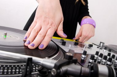 Hands of female hip-hop DJ scratching clipart