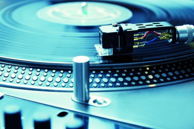 Turntable playing vinyl record with music clipart