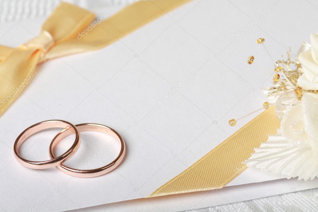 Wedding rings and wedding invitation with bow