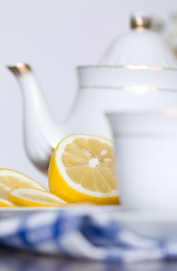 Lemon and tea set on white background clipart