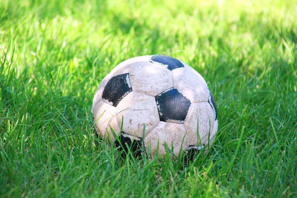 stock image Old soccer ball on grass