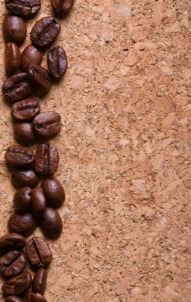 Coffee beans on a corkwood texture background — Stock Photo, Image