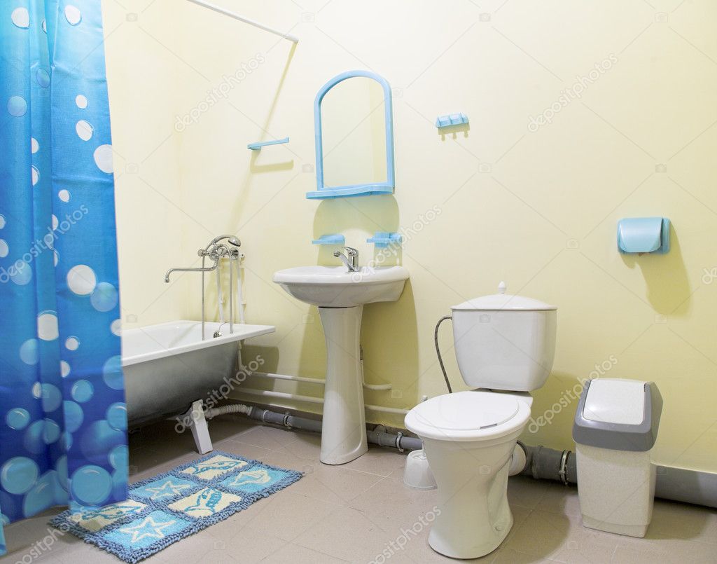 Bathroom with white bath and blue curtain