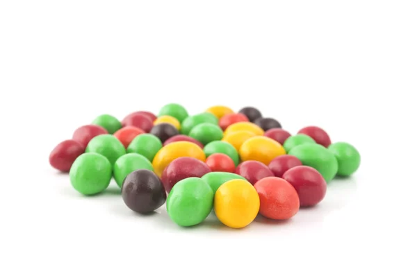 Pills with peanuts covered with multicolored glaze — Stock Photo, Image