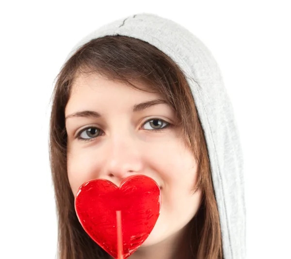 Girl with a heart-shaped candy — Stock Photo, Image