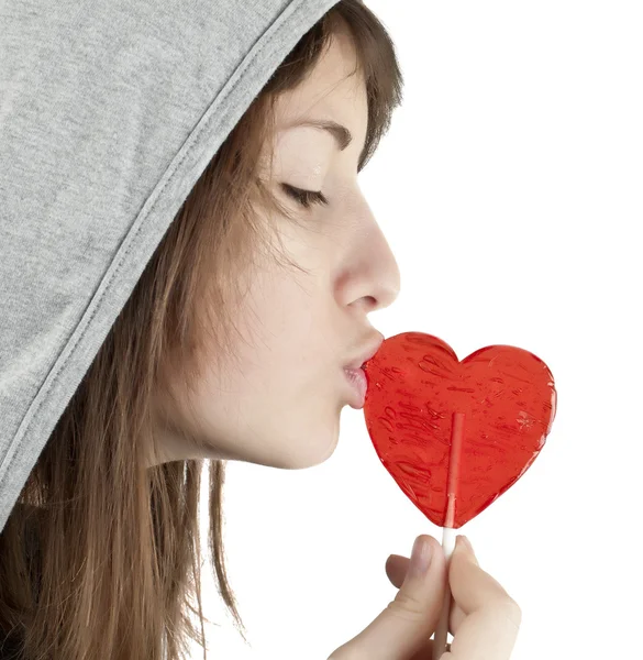 Candy red heart in the girl's lips — Stock Photo, Image