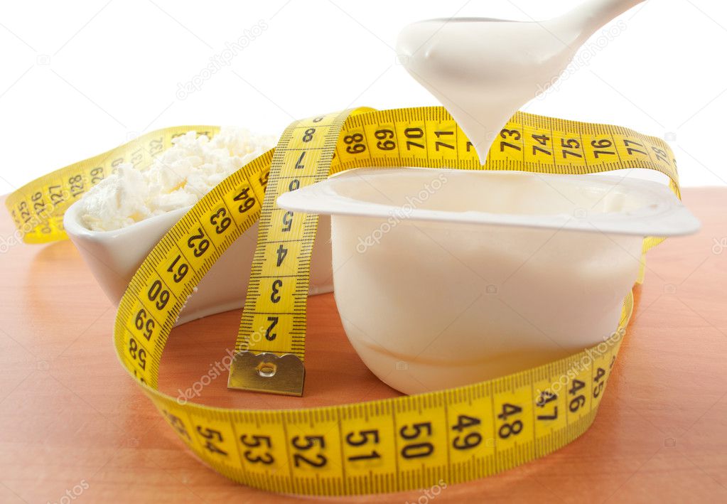 cottage cheese and yogurt with a centimeter tape on a wooden table