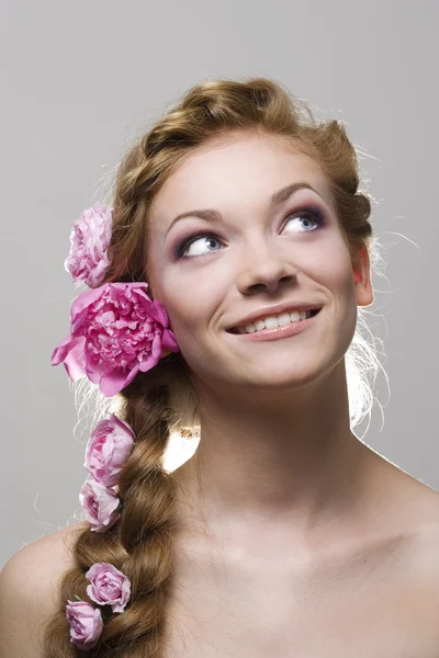 Woman with with braids and roses in hair — Stock Photo, Image