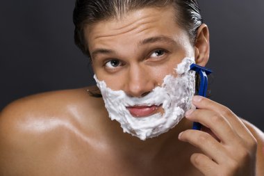 Handsome man shaving clipart
