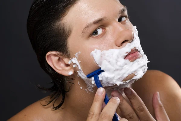Handsome man shaving — Stock Photo, Image