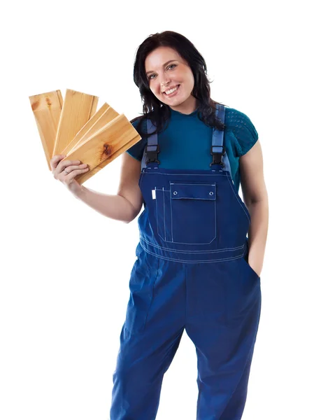Pretty woman in coveralls with the lining boards — Stock Photo, Image