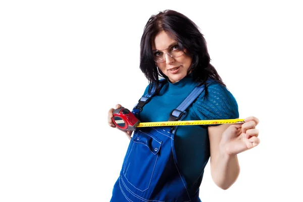 Pretty woman in coveralls with the tape measure — Stock Photo, Image