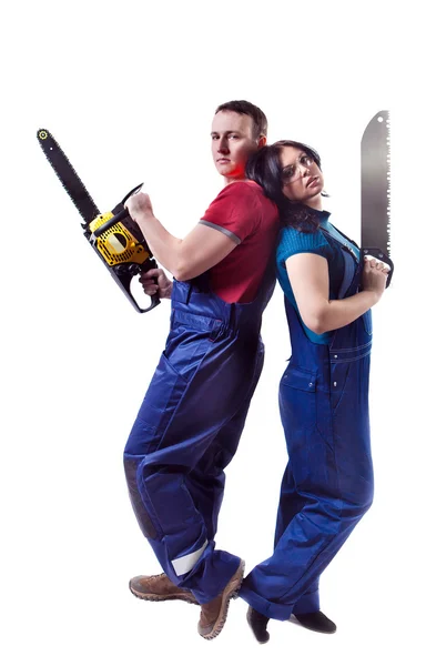 Man and woman with the saw and chainsaw are standing back to bac — Stock Photo, Image