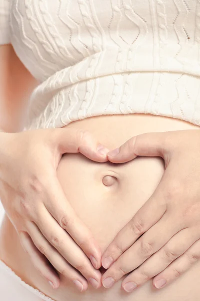 Pregnant caucasian mother with hands on belly — Stock Photo, Image