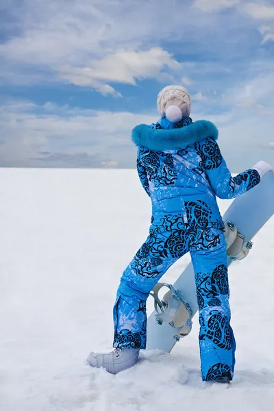 Snowboard girl in blue stay at the bottom of hill — Stock Photo, Image