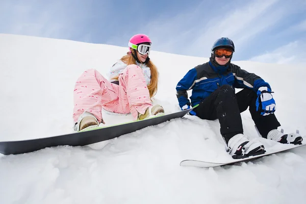 Two person sit on snow and preparing to ride — Stock Photo, Image