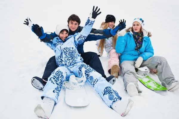 Four snowborders sit on snow — Stock Photo, Image