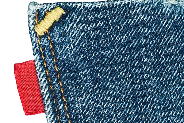 Blue old jeans pocket with empty red label — Stock Photo, Image