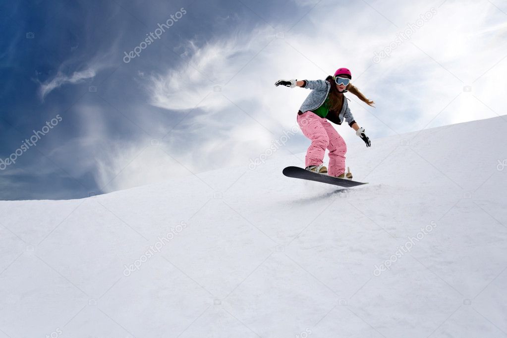 Girl rider jump on snowboard in mountains