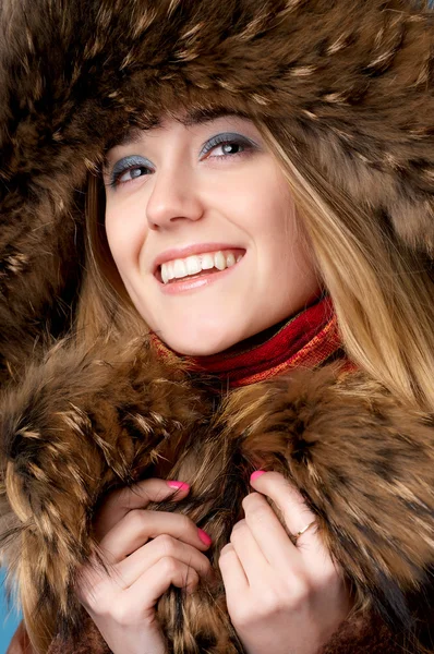 Closeup portrait of young beautiful girl wearing fur cap — Stock Photo, Image
