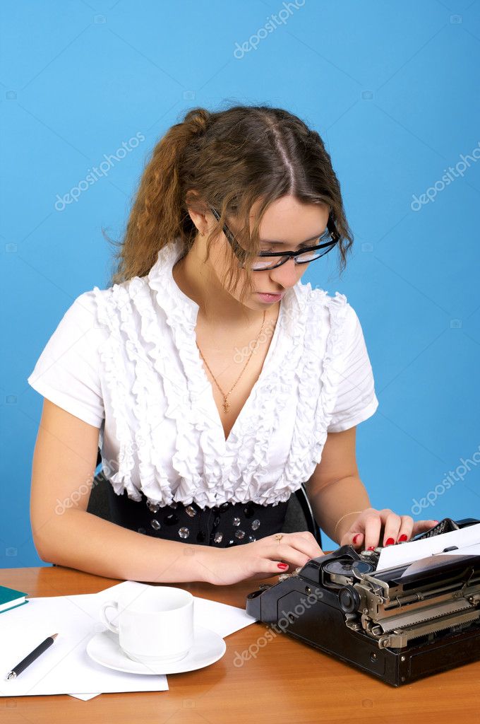 Cute female author with vintage typewriter