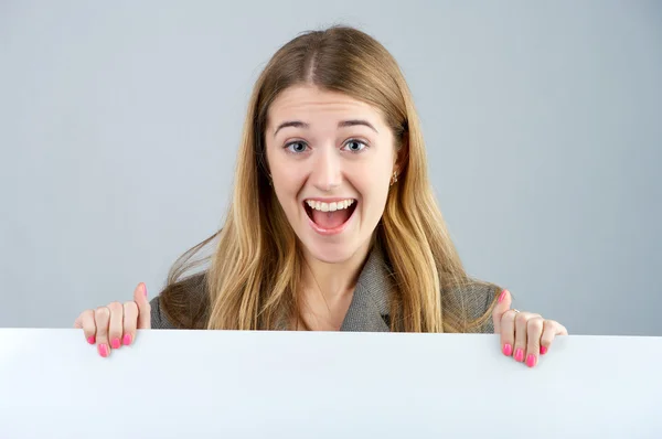stock image Young female holding a blank billboard