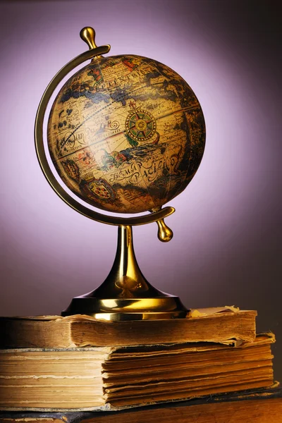 Antique globe on books — Stock Photo, Image
