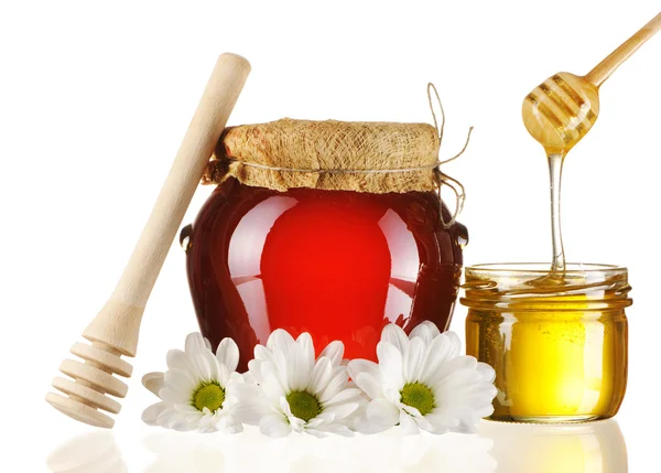 Sklenice medu a naběračky — Stock fotografie