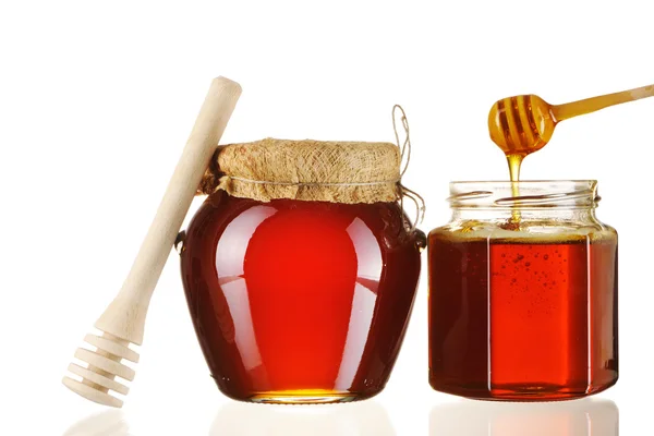 Sklenice medu a naběračky — Stock fotografie
