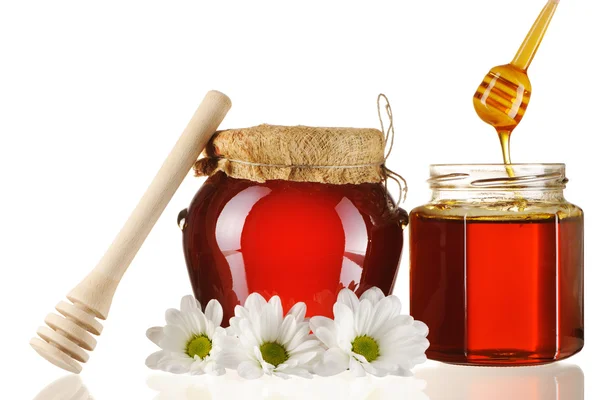 Jars of honey and dipper — Stock Photo, Image