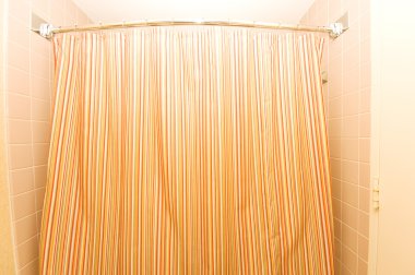 Bath tub behind striped colourful curtain clipart