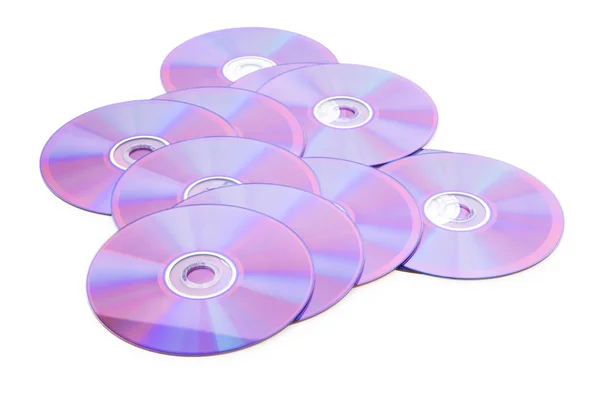 De nombreux DVD sont isolés sur le fond blanc — Photo