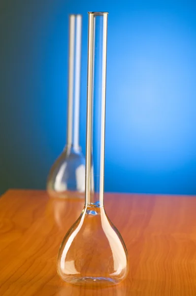 Retorty szklane przed niebieskie tło gradientowe — Zdjęcie stockowe